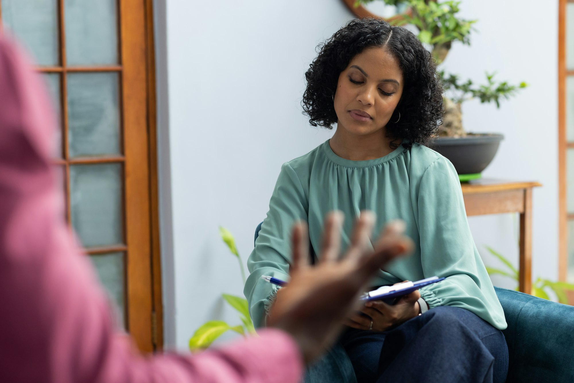 African american male patient attending therapy with biracial female therapist